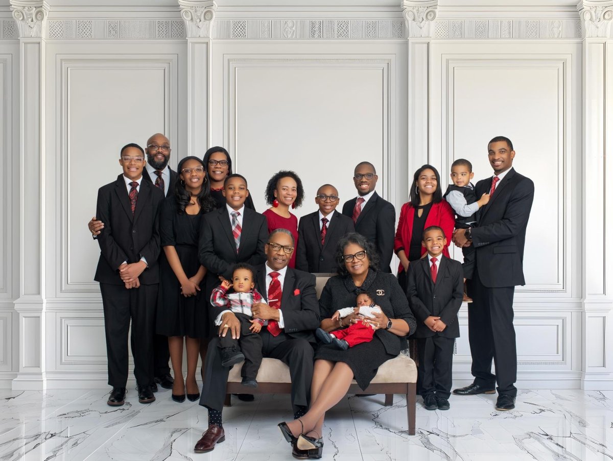 The Quick family — Apostle Tommy E. Quick and Lady Valerie Quick surrounded by their children and grandchildren
